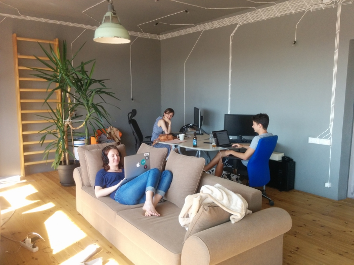 Example of a company with a modern office that has elements like a sofa and a ladder. It's a nice example for employer branding.